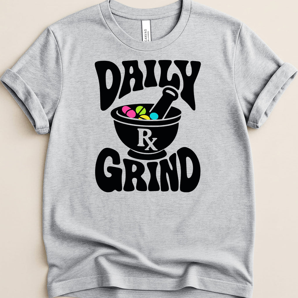 Gray t-shirt featuring black text "DAILY GRIND" and a mortar and pestle with colorful pills.