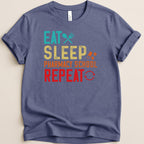 Blue t-shirt with "Eat Sleep Pharmacy School Repeat" text and icons.