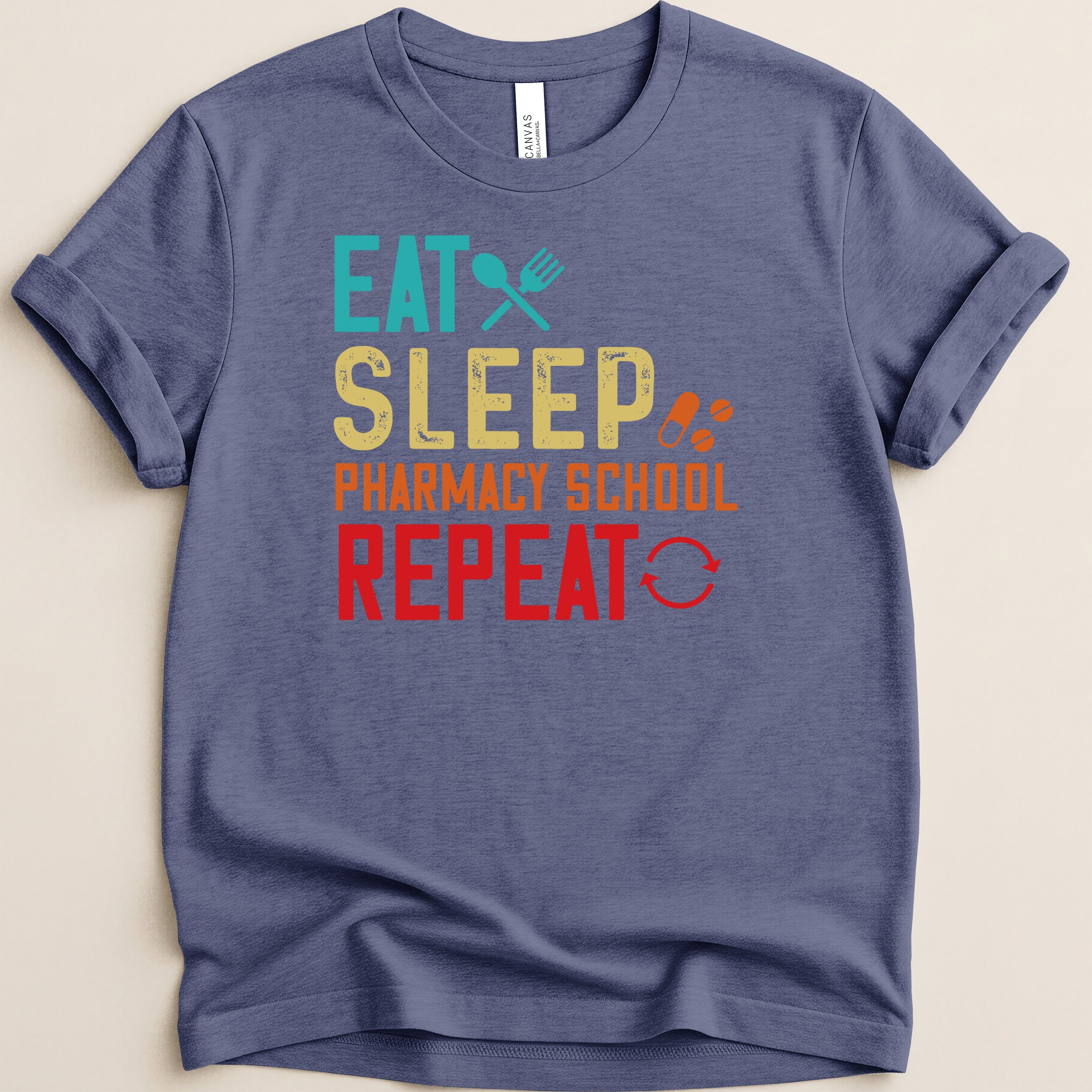Blue t-shirt with "Eat Sleep Pharmacy School Repeat" text and icons.