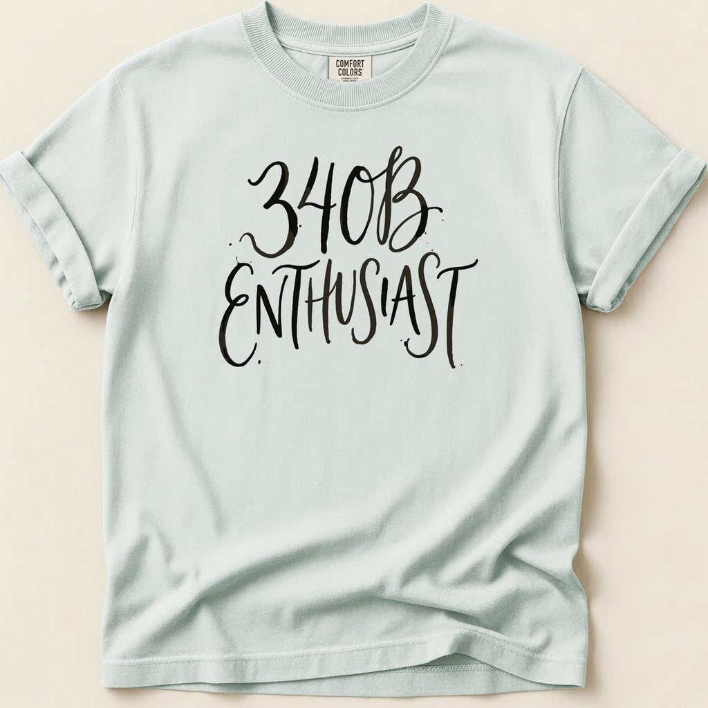 Light blue t-shirt with black script text reading "340B ENTHUSIAST".