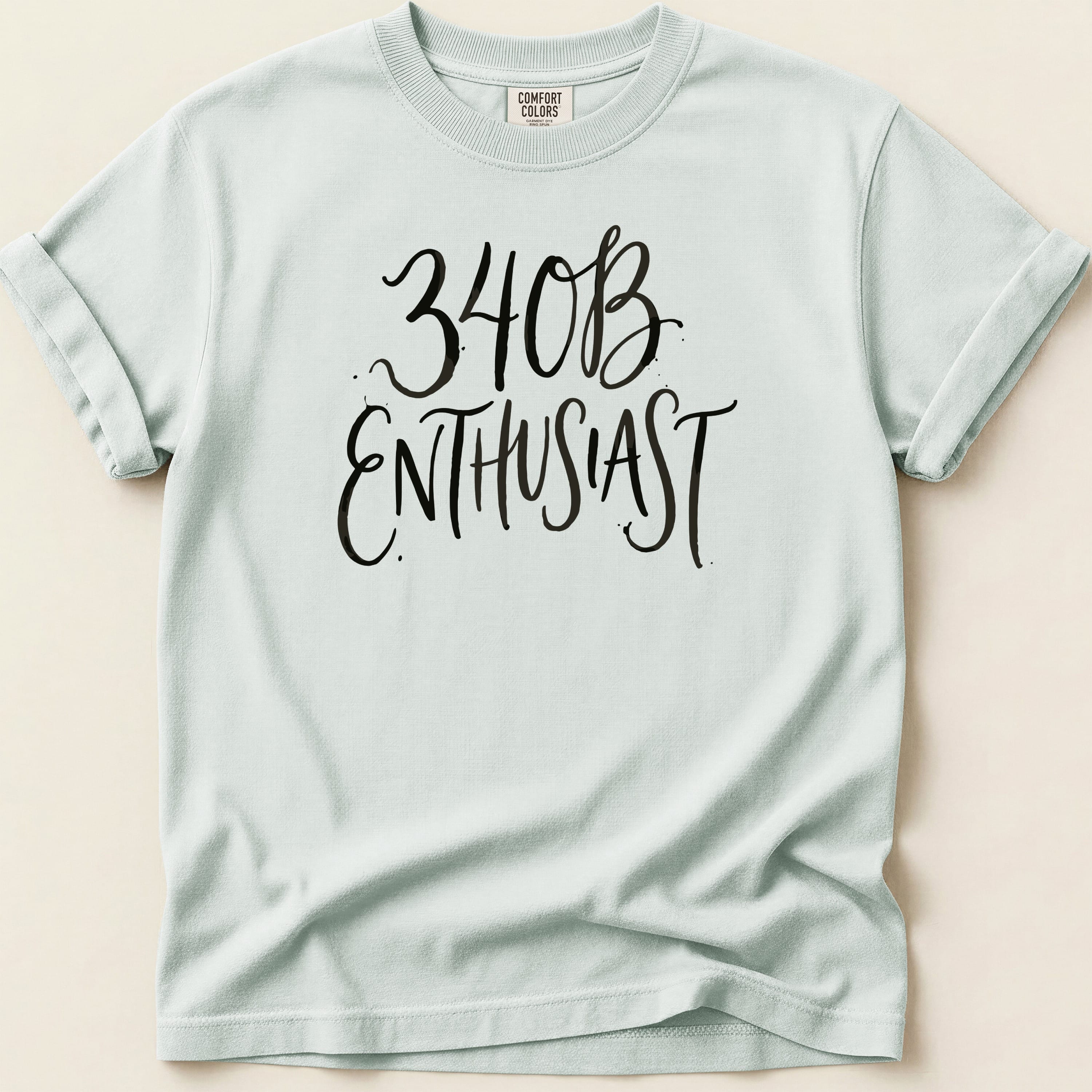 Light blue t-shirt with black script text reading "340B ENTHUSIAST".