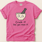 Pink t-shirt with mortar and pestle graphic and text "Crush it like you mean it."