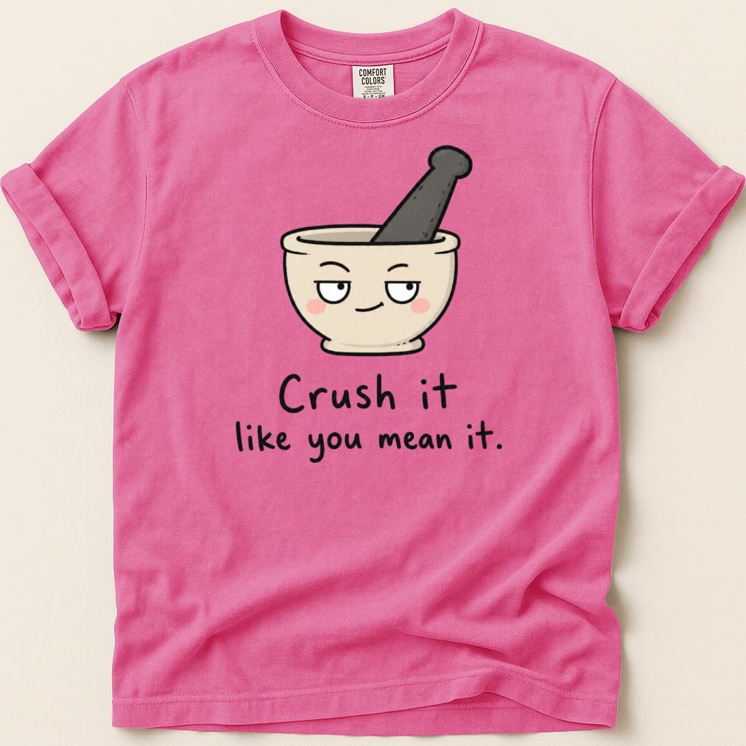 Pink t-shirt with mortar and pestle graphic and text "Crush it like you mean it."