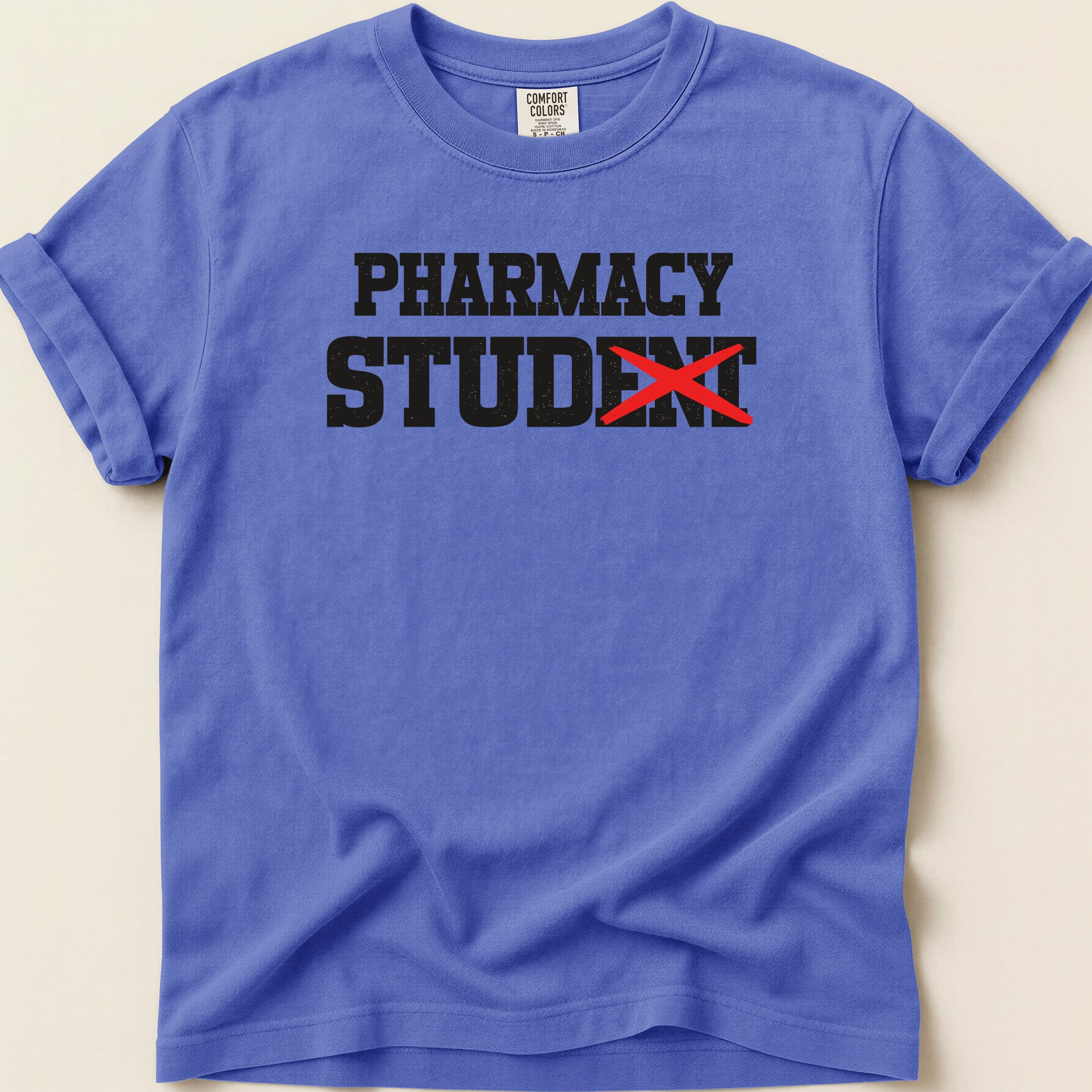 Blue t-shirt with "PHARMACY STUDENT" text, red line through "ST".