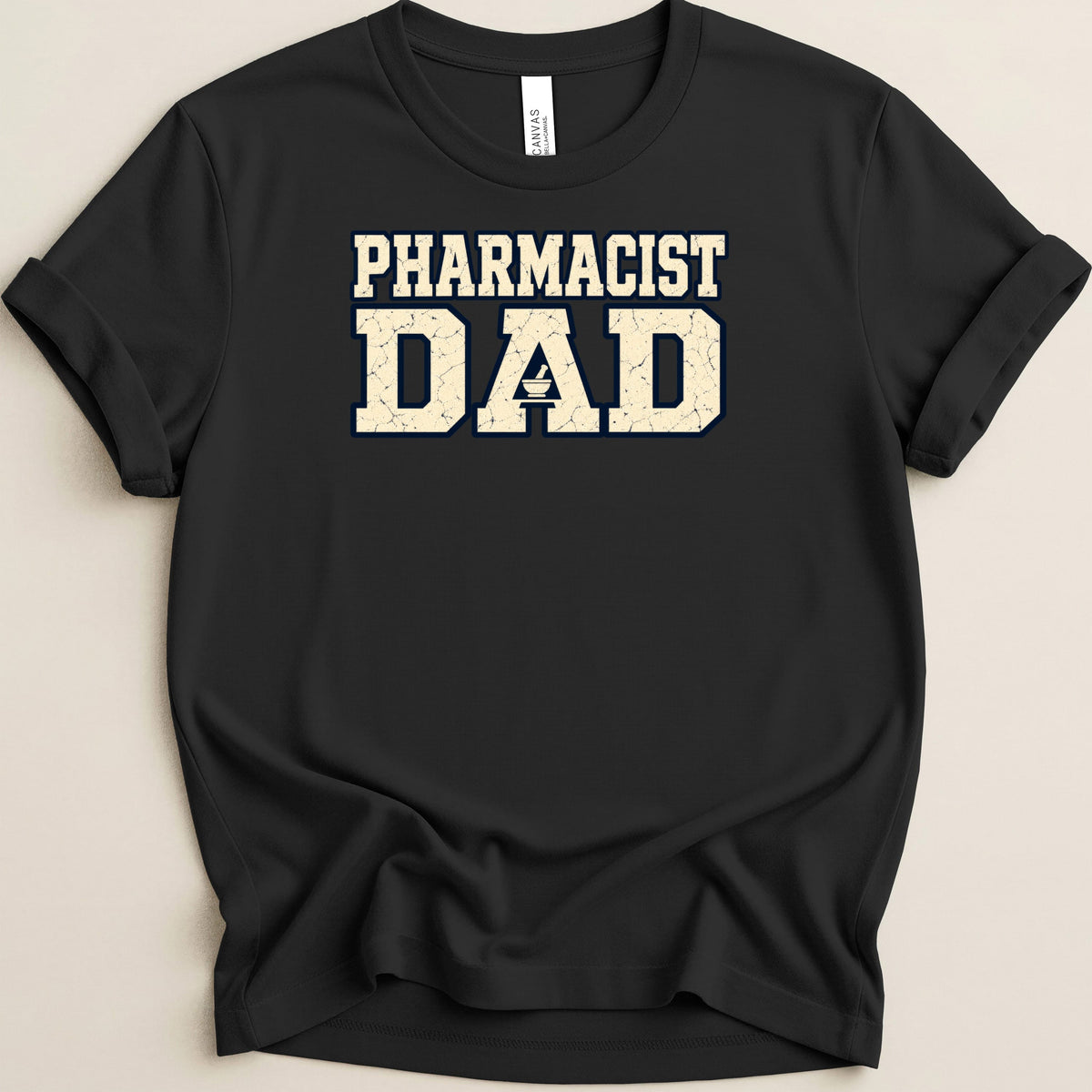 Black t-shirt with rolled sleeves featuring distressed white and blue text that reads Pharmacist Dad.