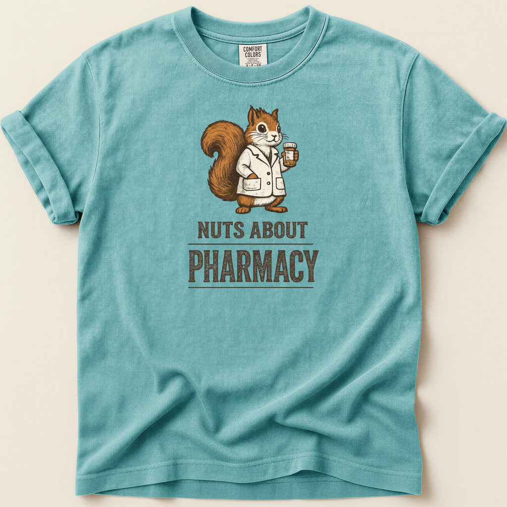 Teal t-shirt with a squirrel in a lab coat holding a prescription bottle and the text "Nuts About Pharmacy".