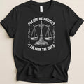 Black t-shirt with scales of justice and text "Please be patient I am from the 1900's".