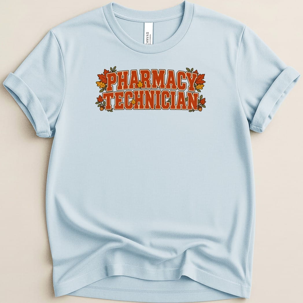 Light blue t-shirt with orange collegiate-style text reading "PHARMACY TECHNICIAN" framed by autumn leaves.