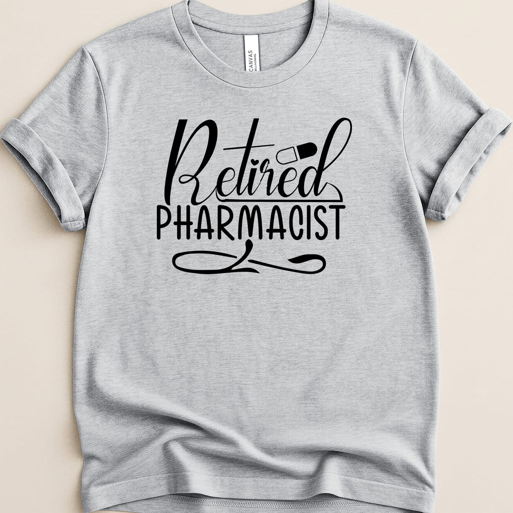 Grey t-shirt with "Retired Pharmacist" text and a capsule graphic.