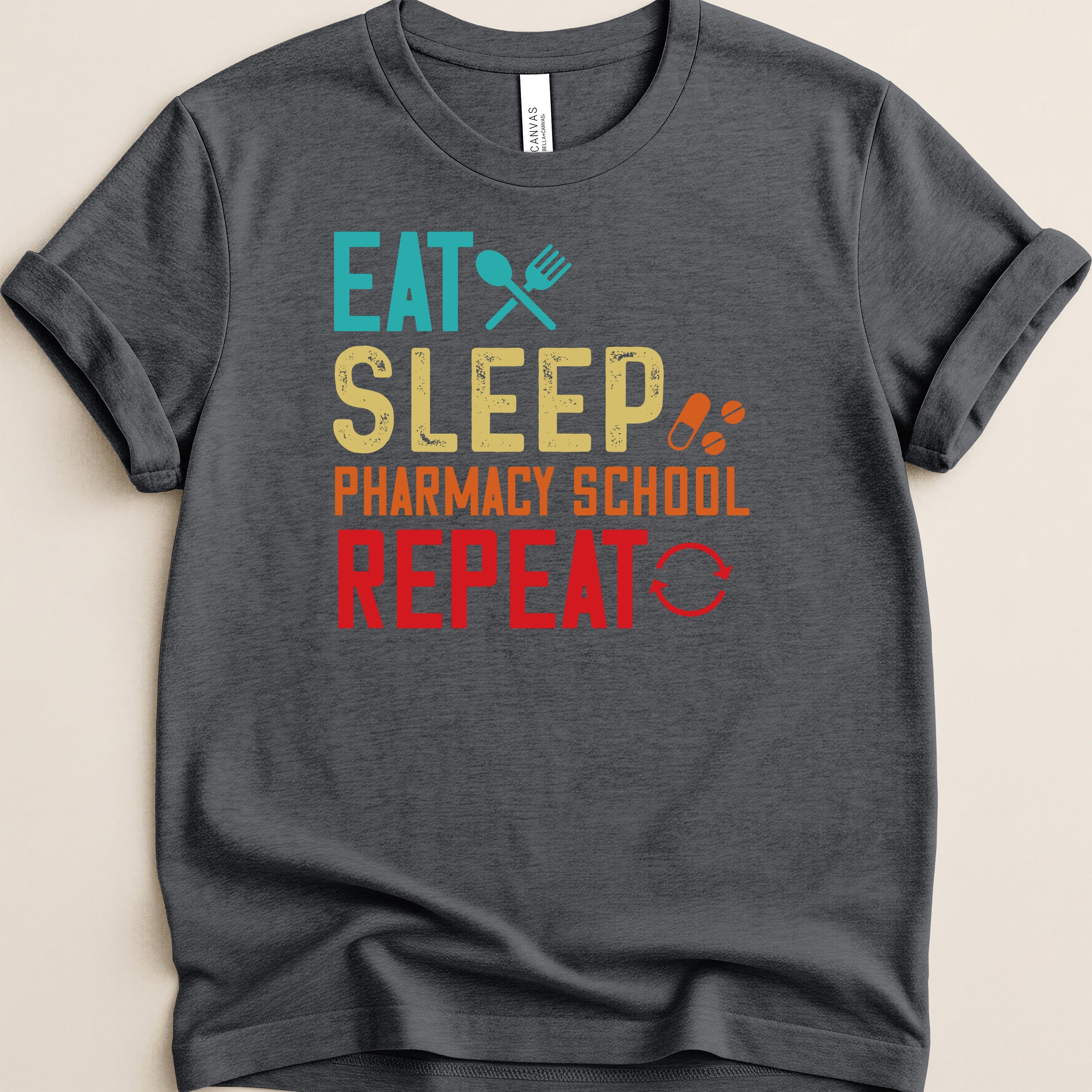 Dark t-shirt with "Eat Sleep Pharmacy School Repeat" text and icons.