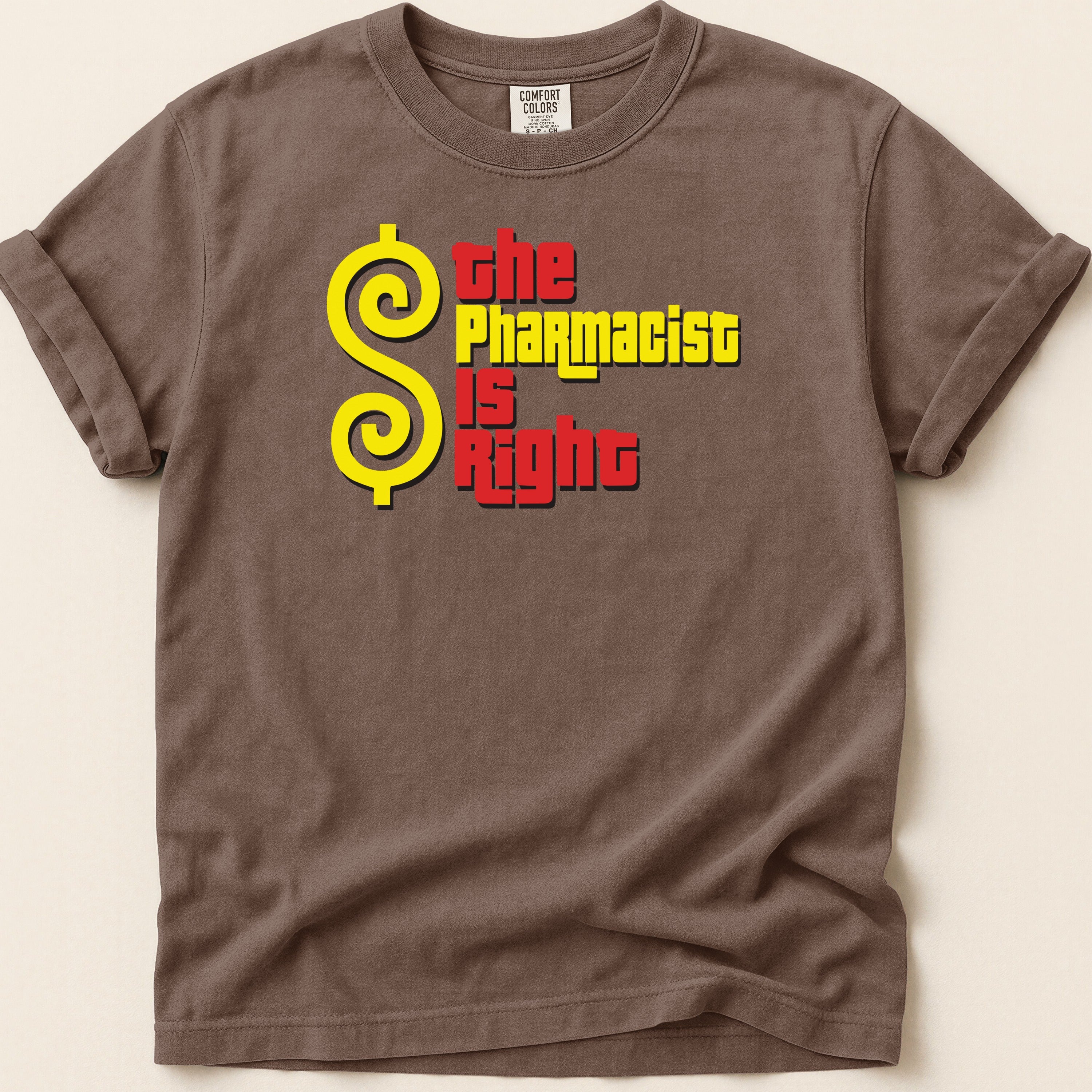 Brown t-shirt with yellow dollar sign and red text: "The Pharmacist Is Right".