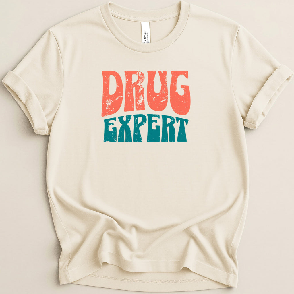 Cream t-shirt with distressed "DRUG EXPERT" text in orange and teal.