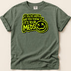 Green t-shirt with "If you're happy and you know it, it's your meds" text and smiley face.