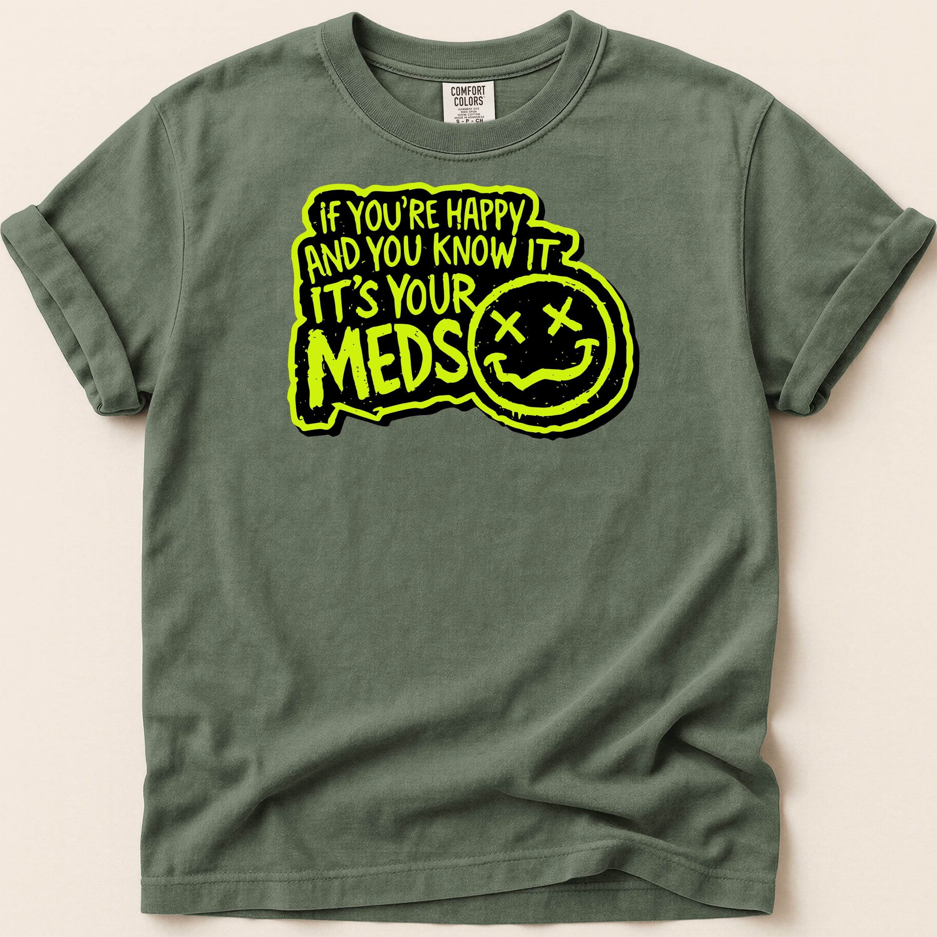Green t-shirt with "If you're happy and you know it, it's your meds" text and smiley face.