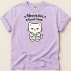 Purple t-shirt with a grumpy cartoon cat wearing a lab coat and the text "Meow's Not a Good Time."