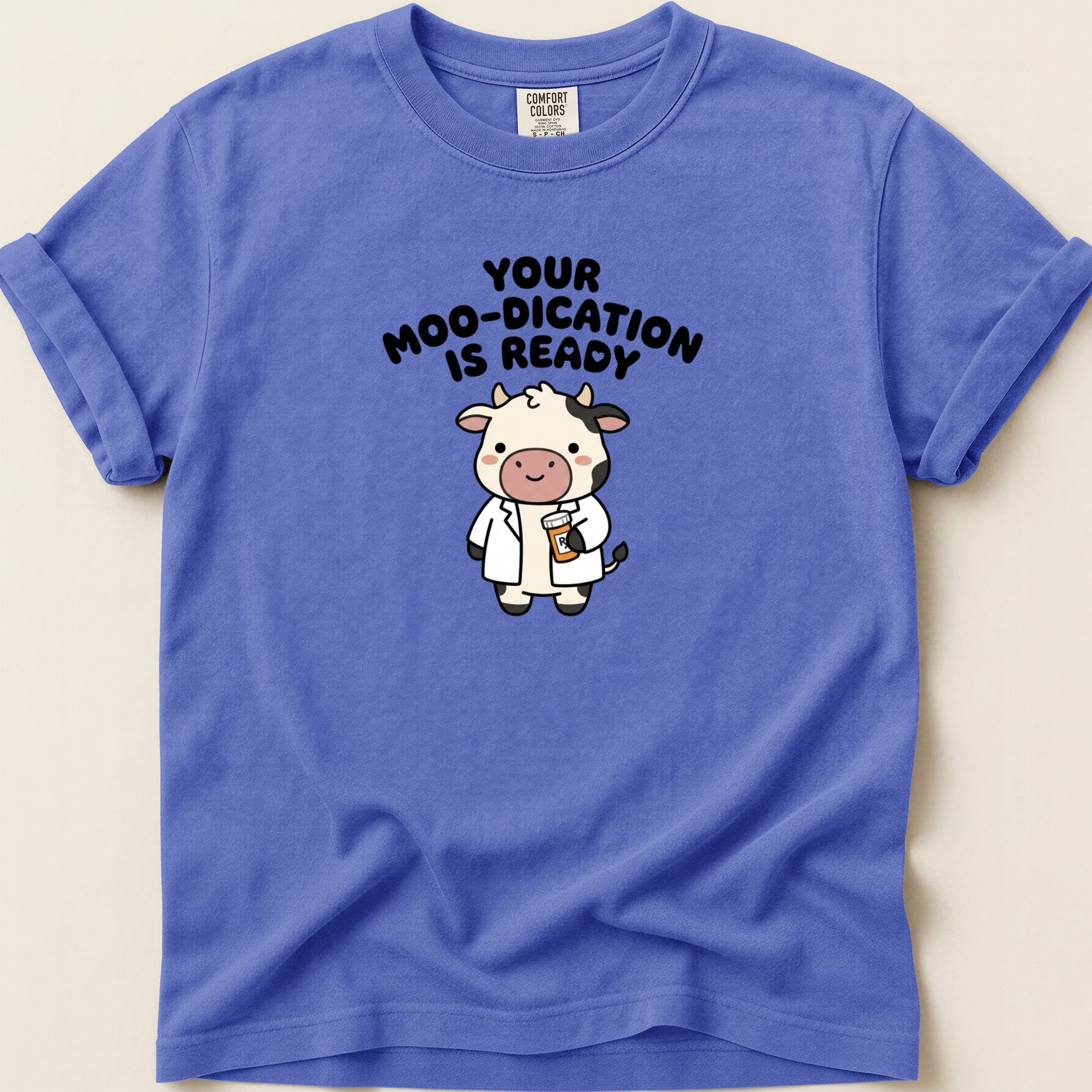 Blue t-shirt with a cartoon cow doctor and text "Your Moo-dication is Ready".