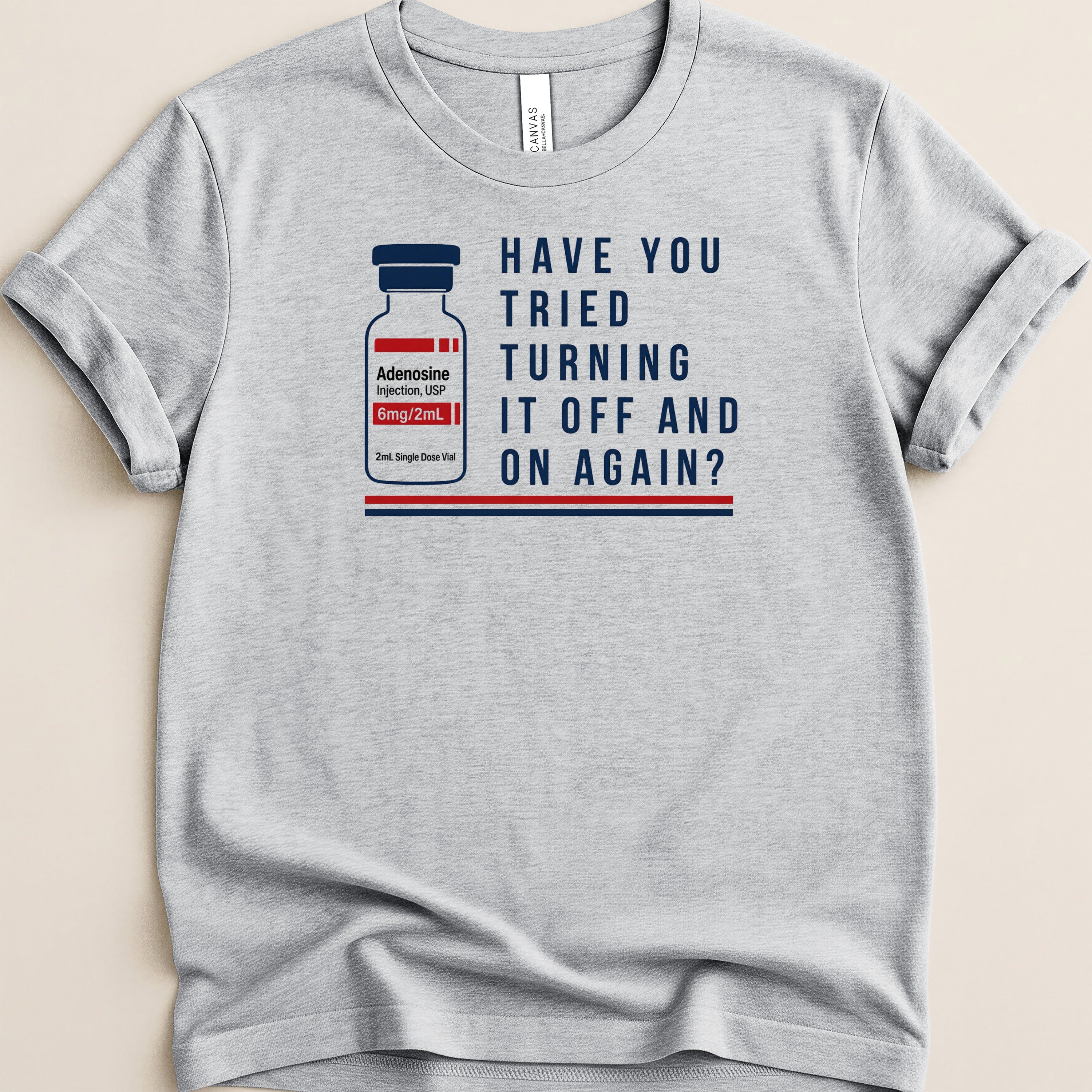 Grey t-shirt with Adenosine injection vial graphic and text "HAVE YOU TRIED TURNING IT OFF AND ON AGAIN?".