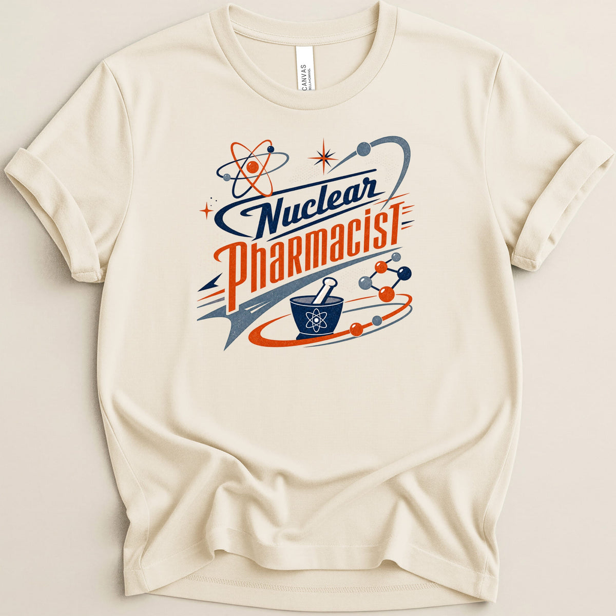 Cream t-shirt with "Nuclear Pharmacist" text and atomic symbols.