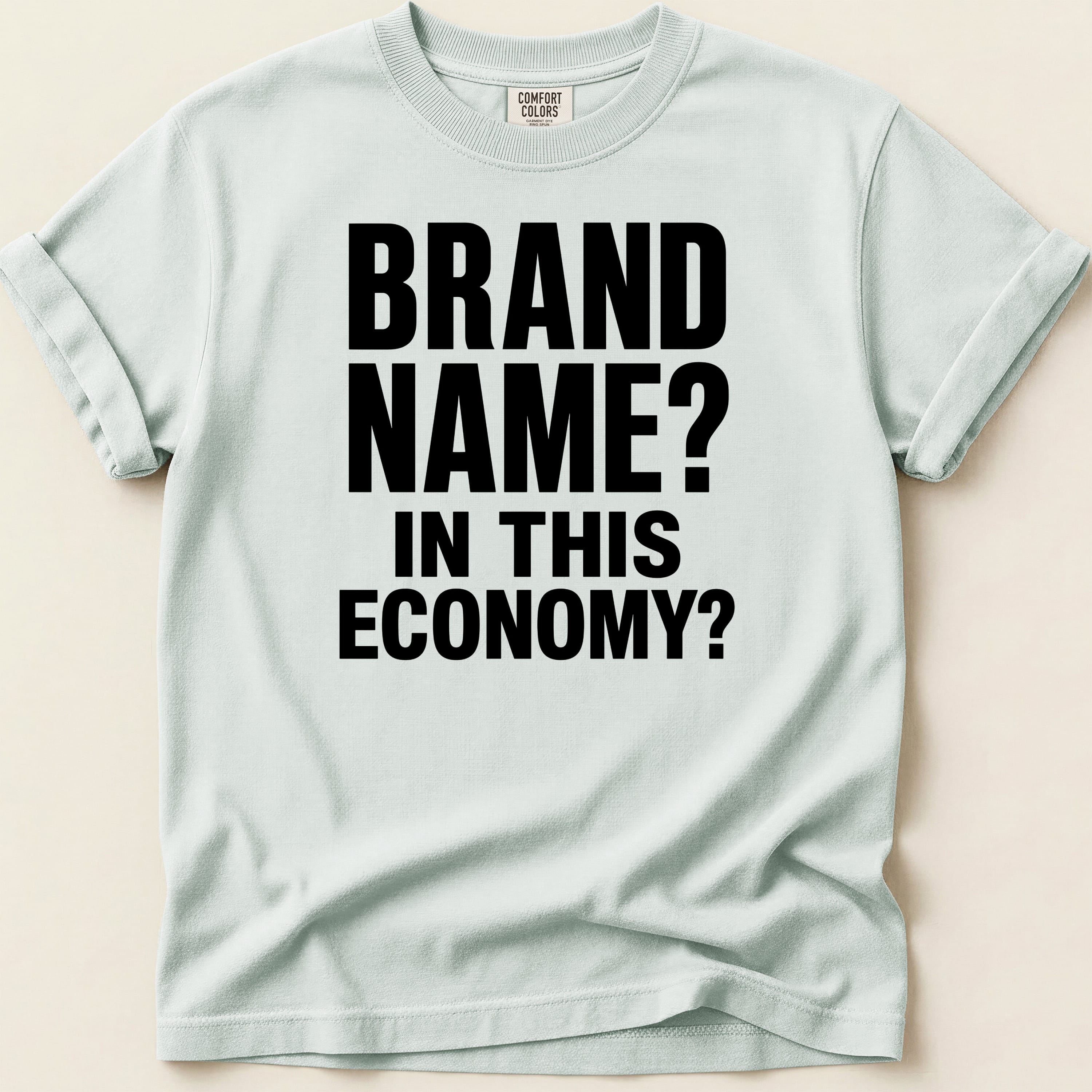 T-shirt with black text: BRAND NAME? IN THIS ECONOMY?