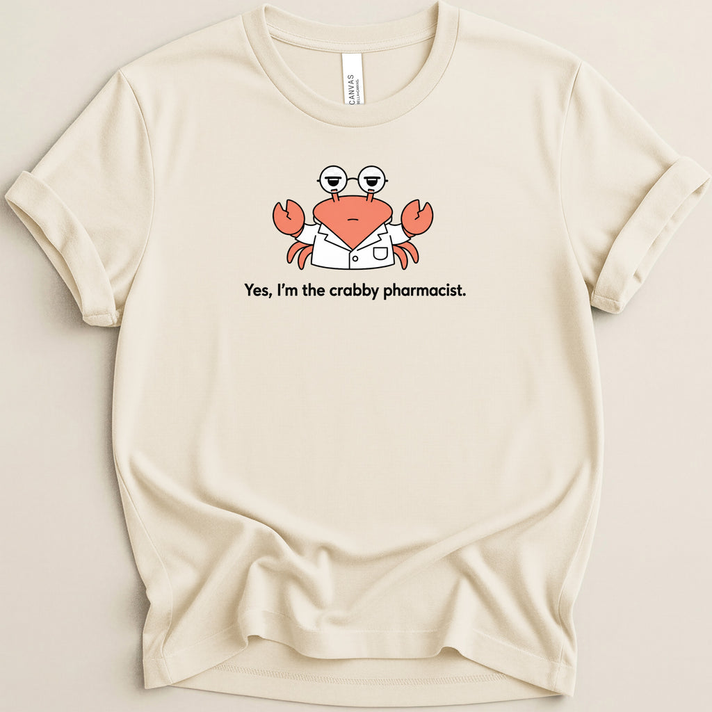 Cream t-shirt with a cartoon crab wearing glasses and a lab coat with text "Yes, I'm the crabby pharmacist."