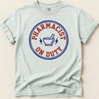 Light blue t-shirt with "Pharmacist On Duty" text and lightning bolt logo.