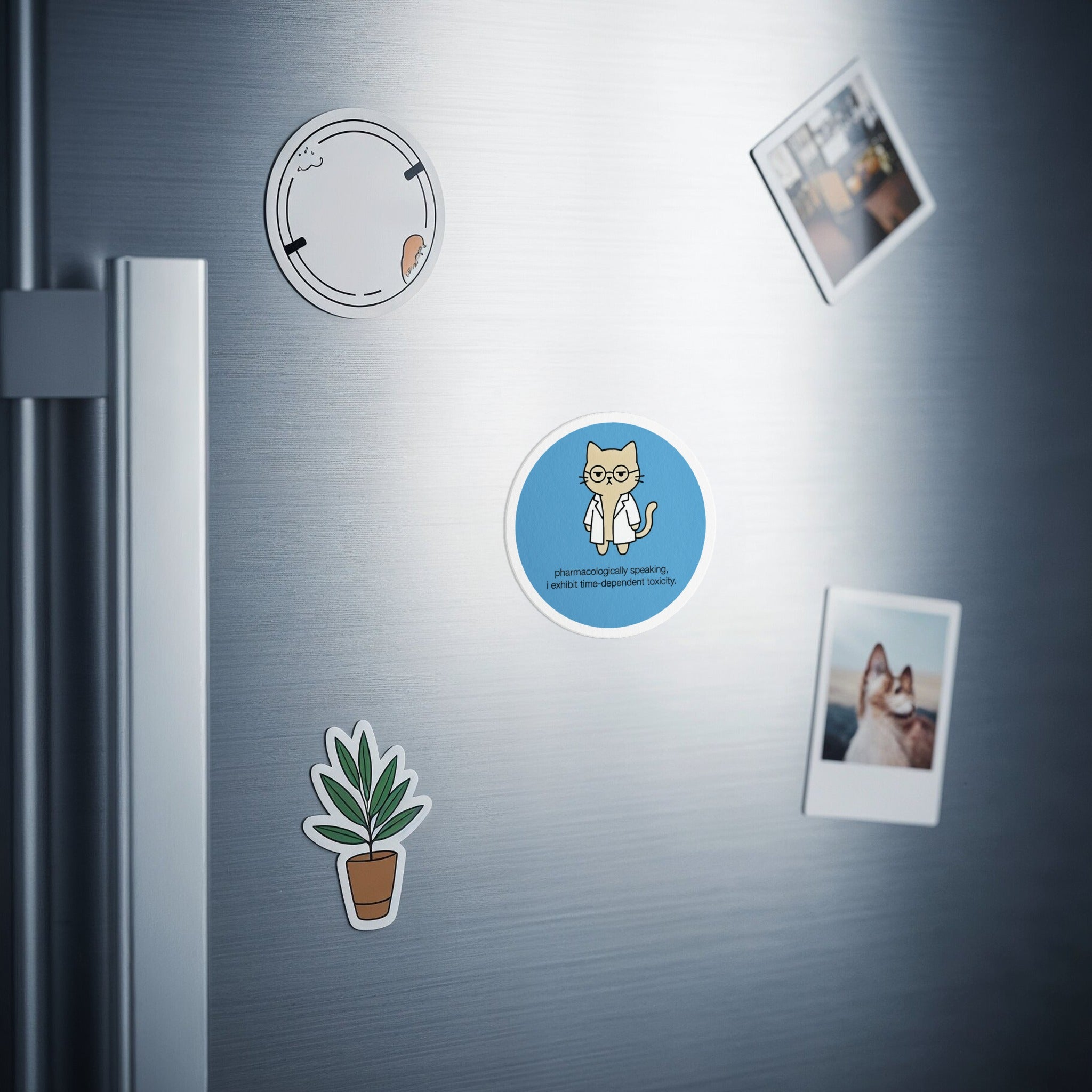Round magnet with cartoon cat wearing glasses and lab coat.