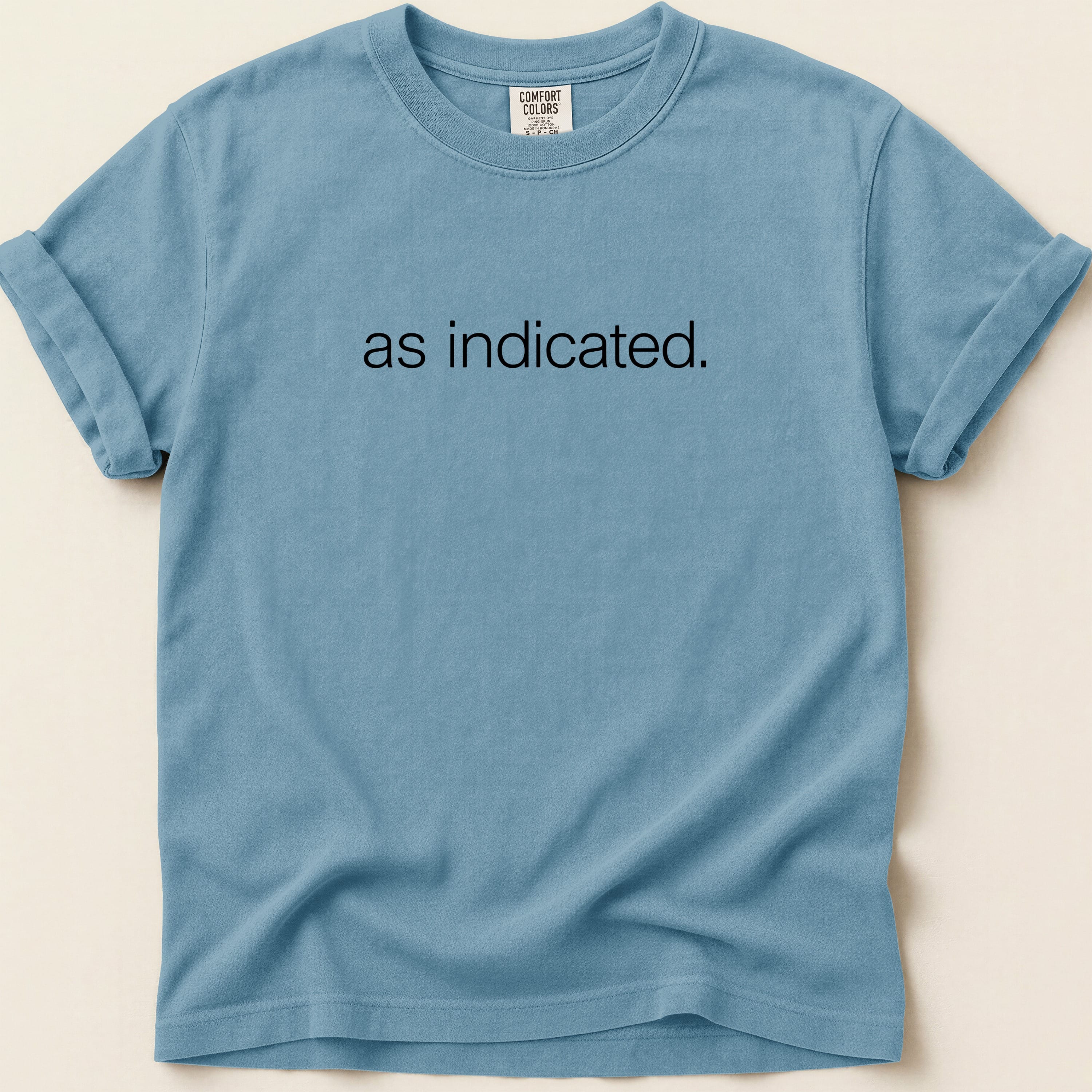 Slate blue t-shirt with "as indicated." printed on the chest.