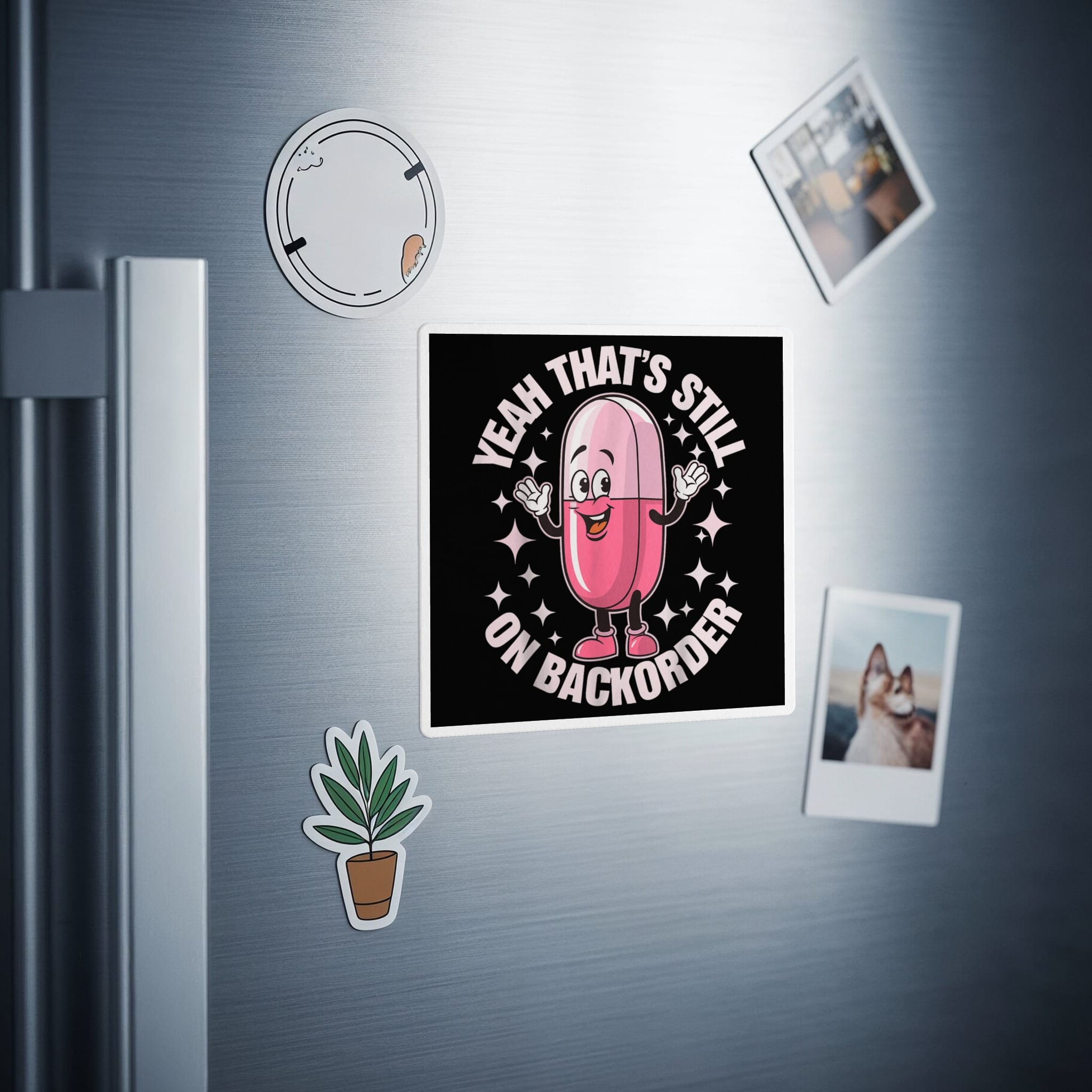 Cartoon pink pill sticker on a refrigerator saying "Yeah, that's still on backorder."
