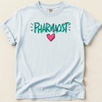 Light blue t-shirt with "PHARMACIST" in teal lettering and a pink heart.