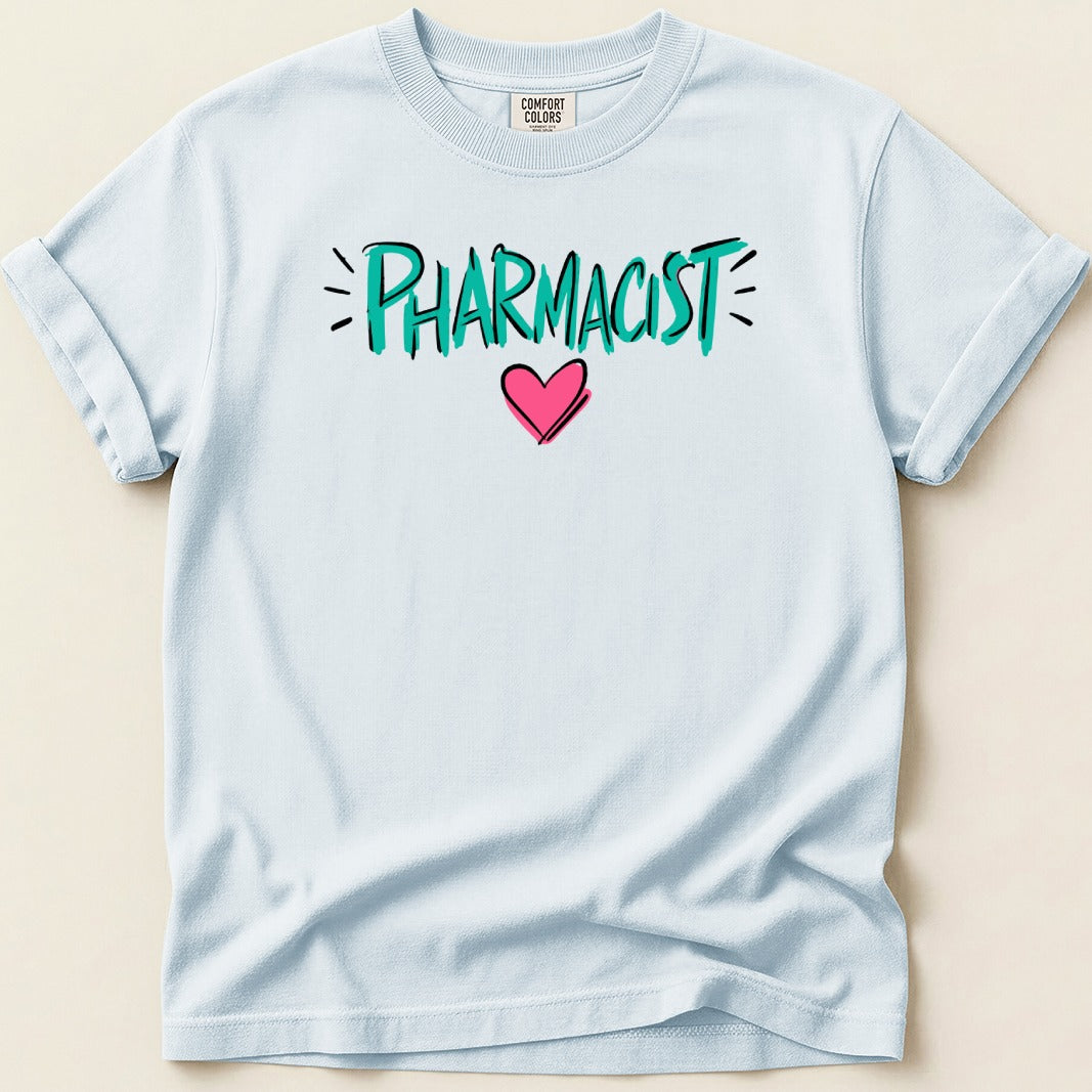 Light blue t-shirt with "PHARMACIST" in teal lettering and a pink heart.