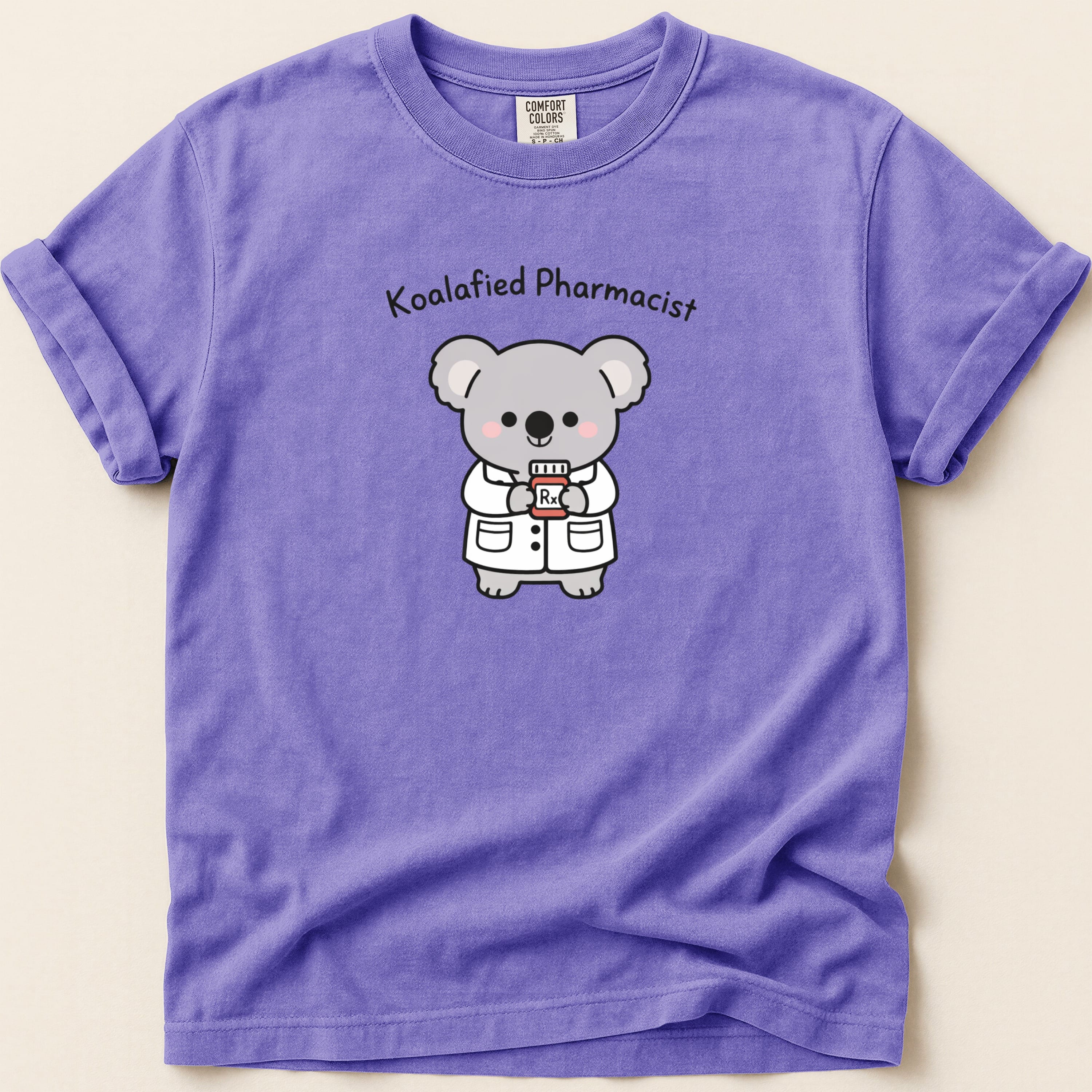 Lavender t-shirt with cartoon koala pharmacist holding a prescription bottle.