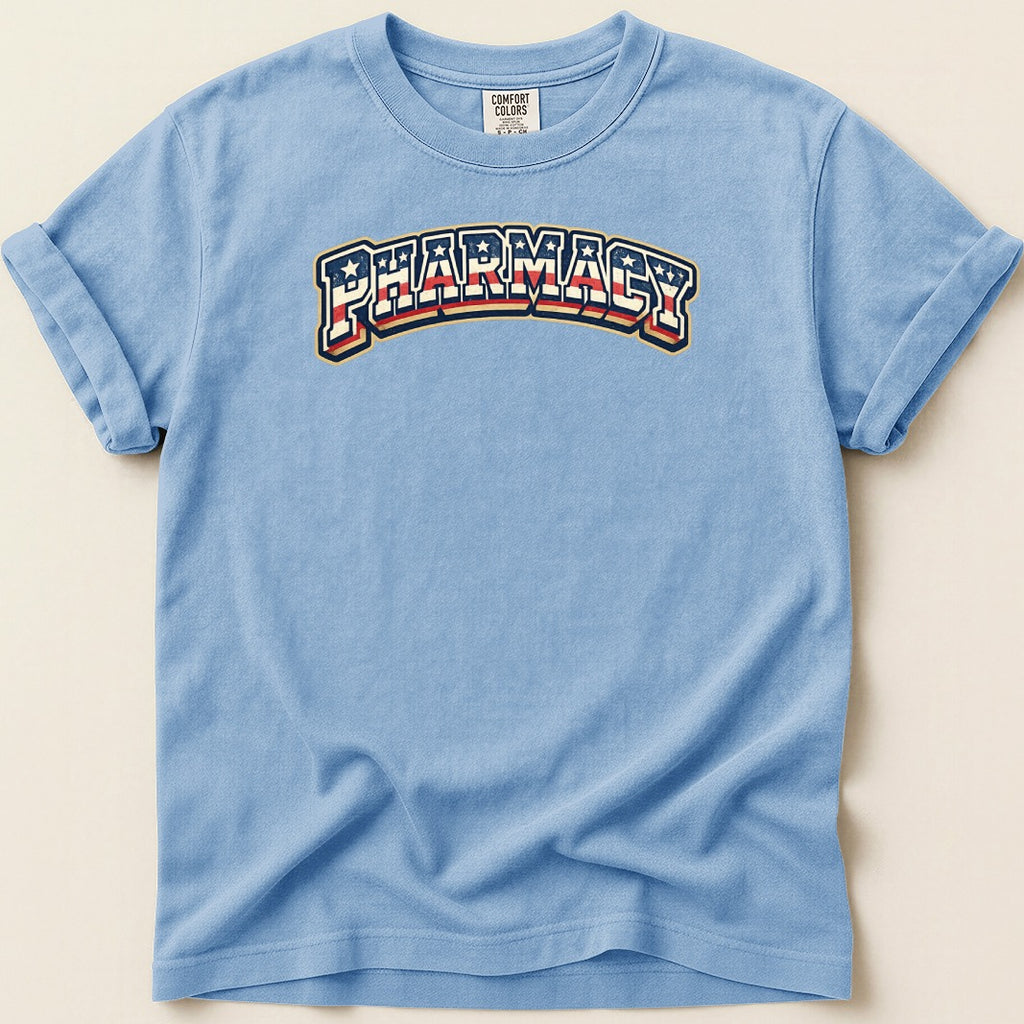 Light blue t-shirt with "PHARMACY" text in red, white, and blue arched design.