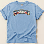 Light blue t-shirt with "PHARMACY" text in red, white, and blue arched design.