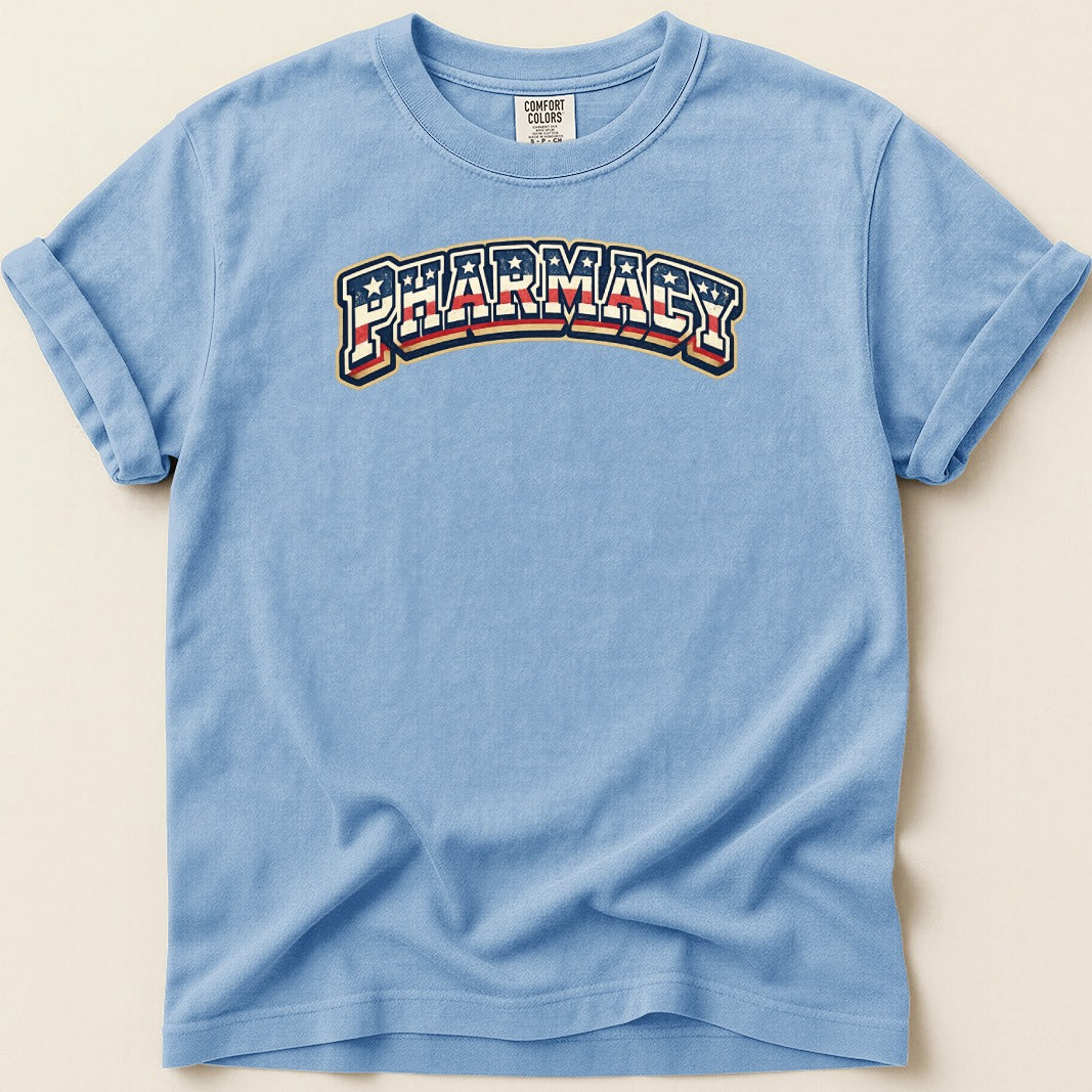 Light blue t-shirt with "PHARMACY" text in red, white, and blue arched design.