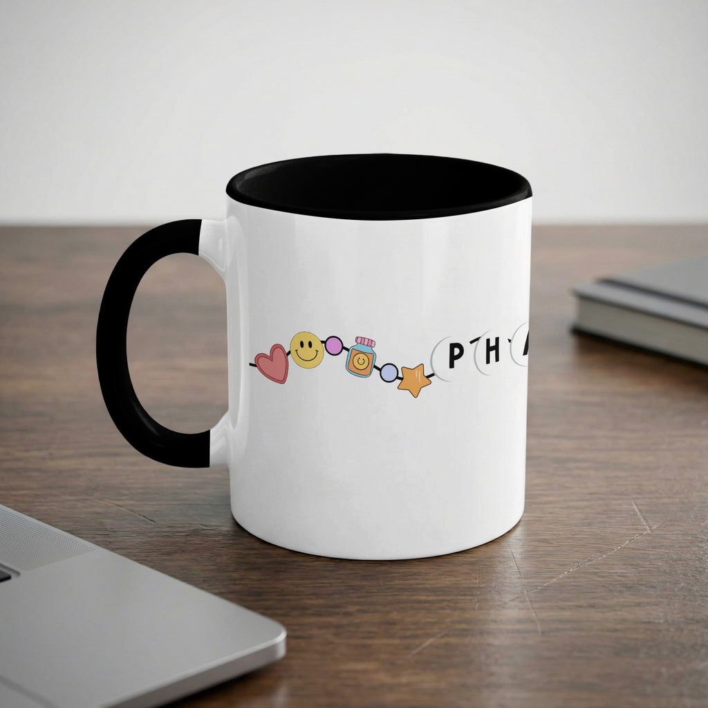 White mug with black handle and rim, featuring colorful emojis and the word "PHRASE".
