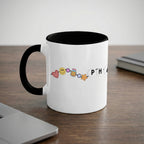 White mug with black handle and rim, featuring colorful emojis and the word "PHRASE".