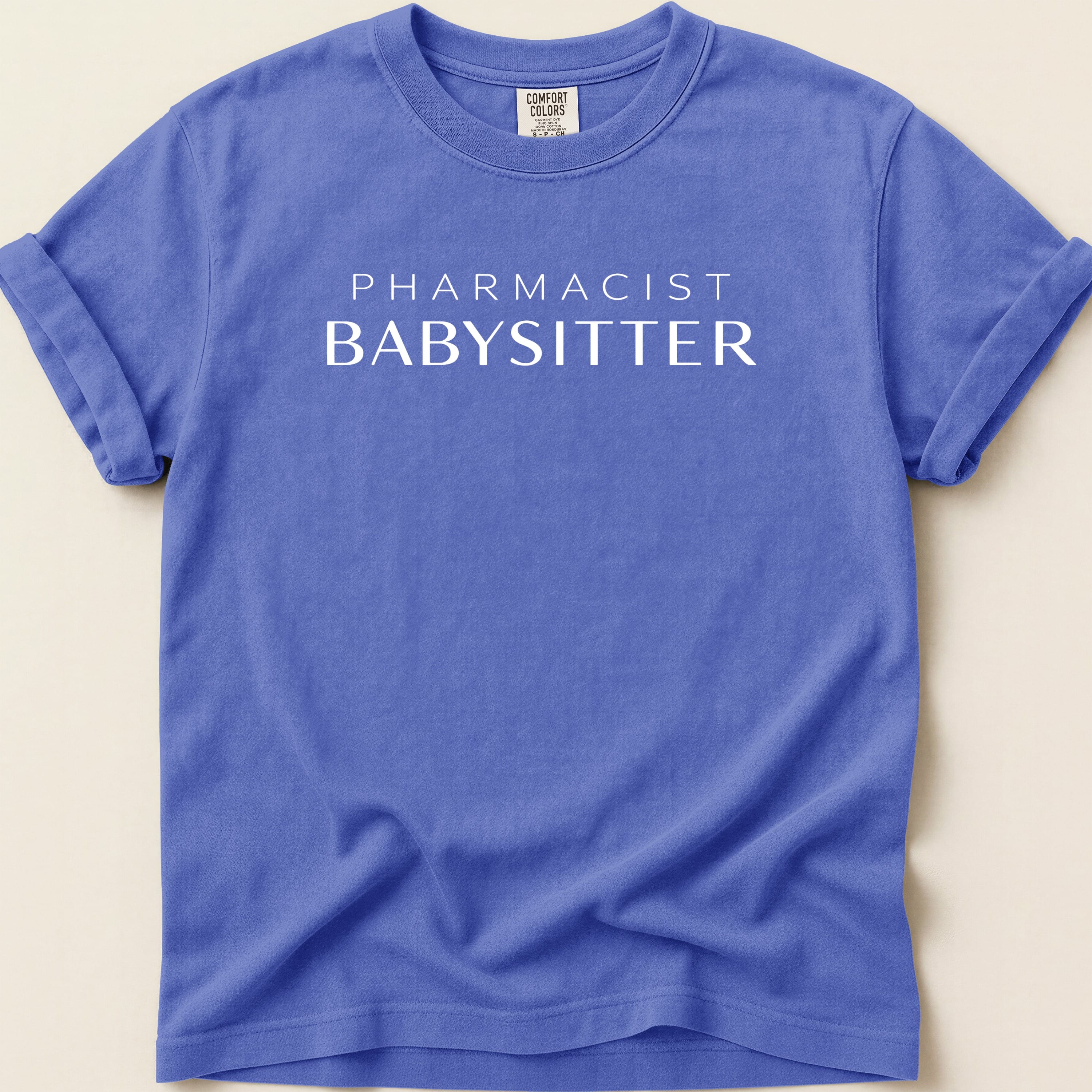 Purple t-shirt with "PHARMACIST BABYSITTER" text.