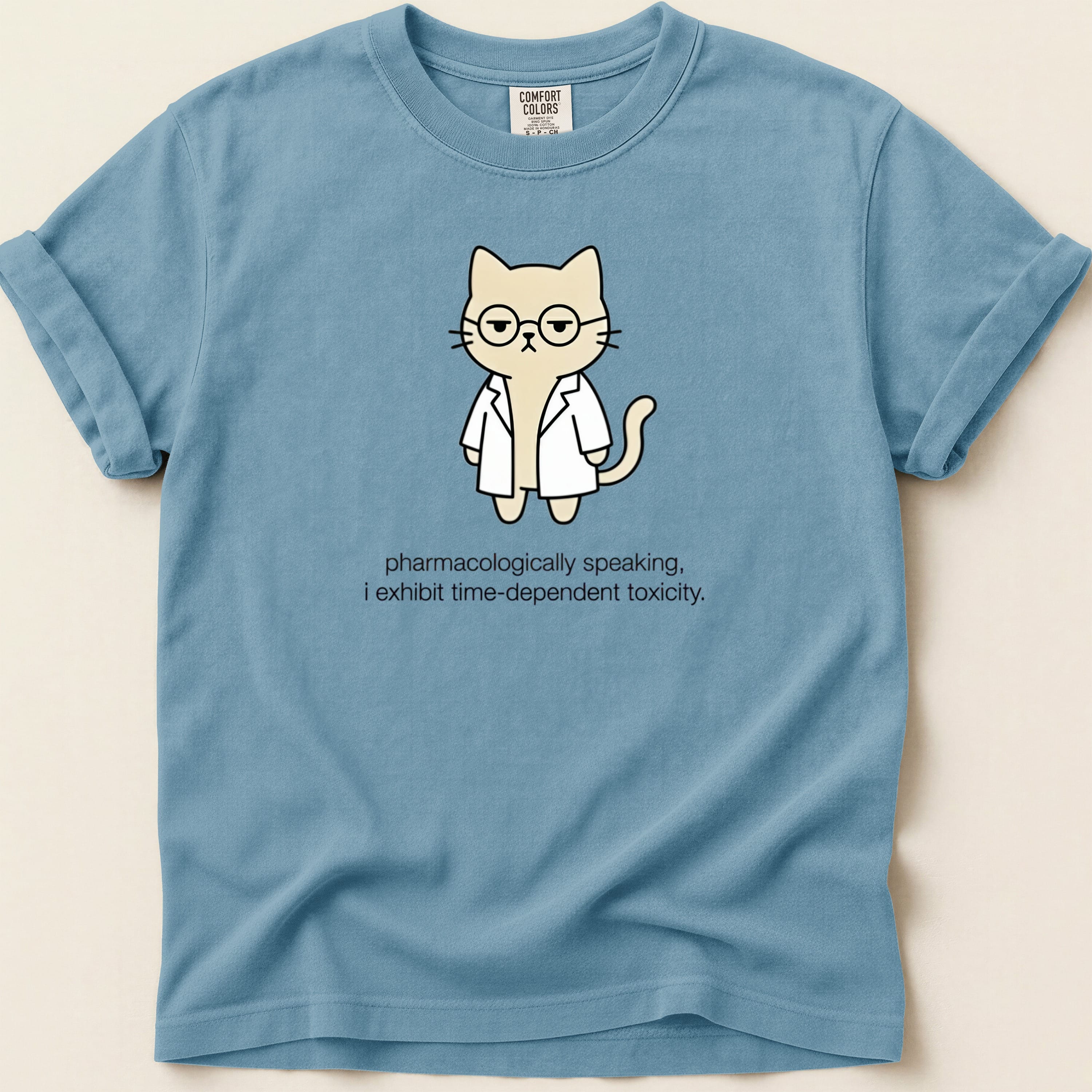 Blue t-shirt with a cartoon cat in a lab coat wearing glasses and text.
