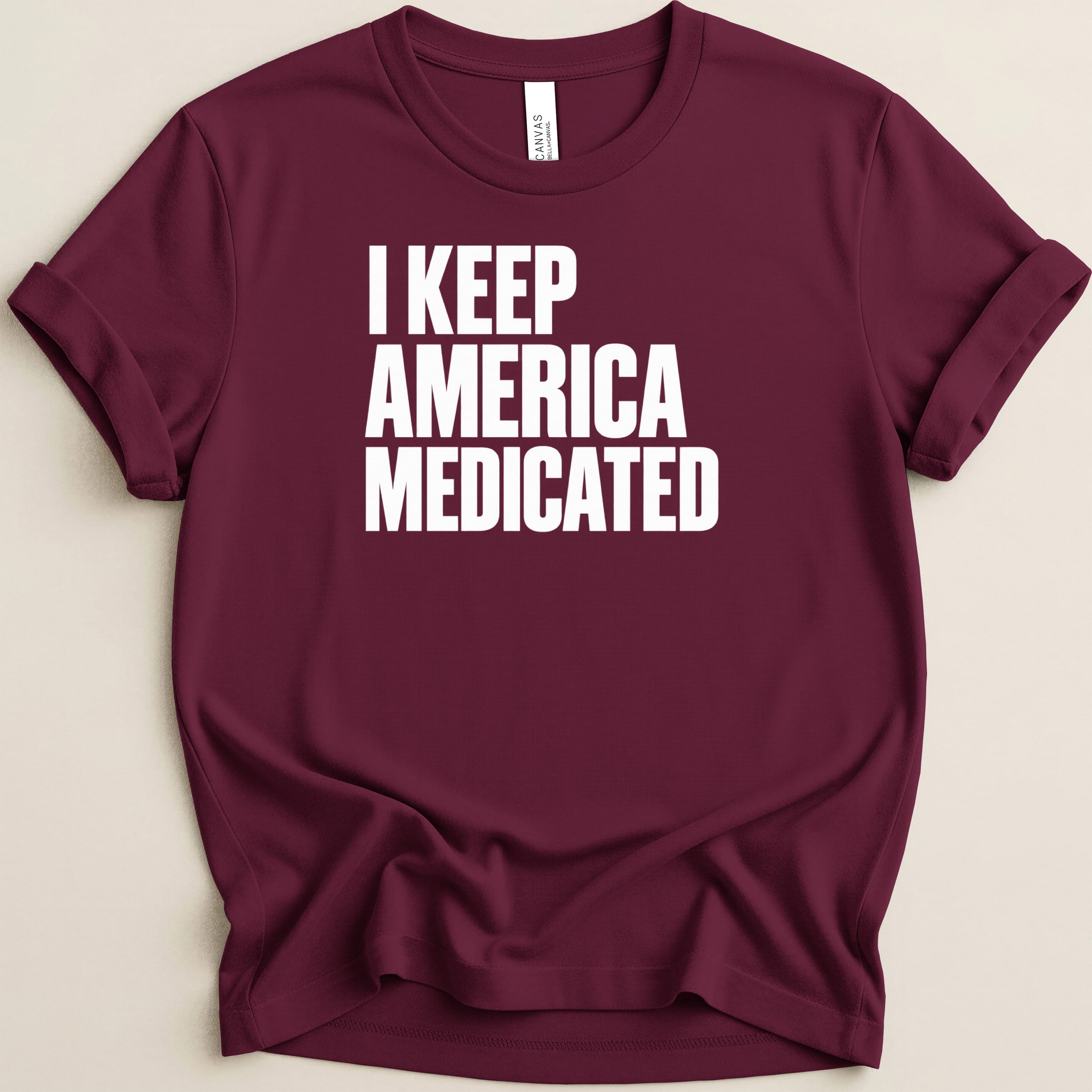 Burgundy t-shirt with white text that reads "I KEEP AMERICA MEDICATED".