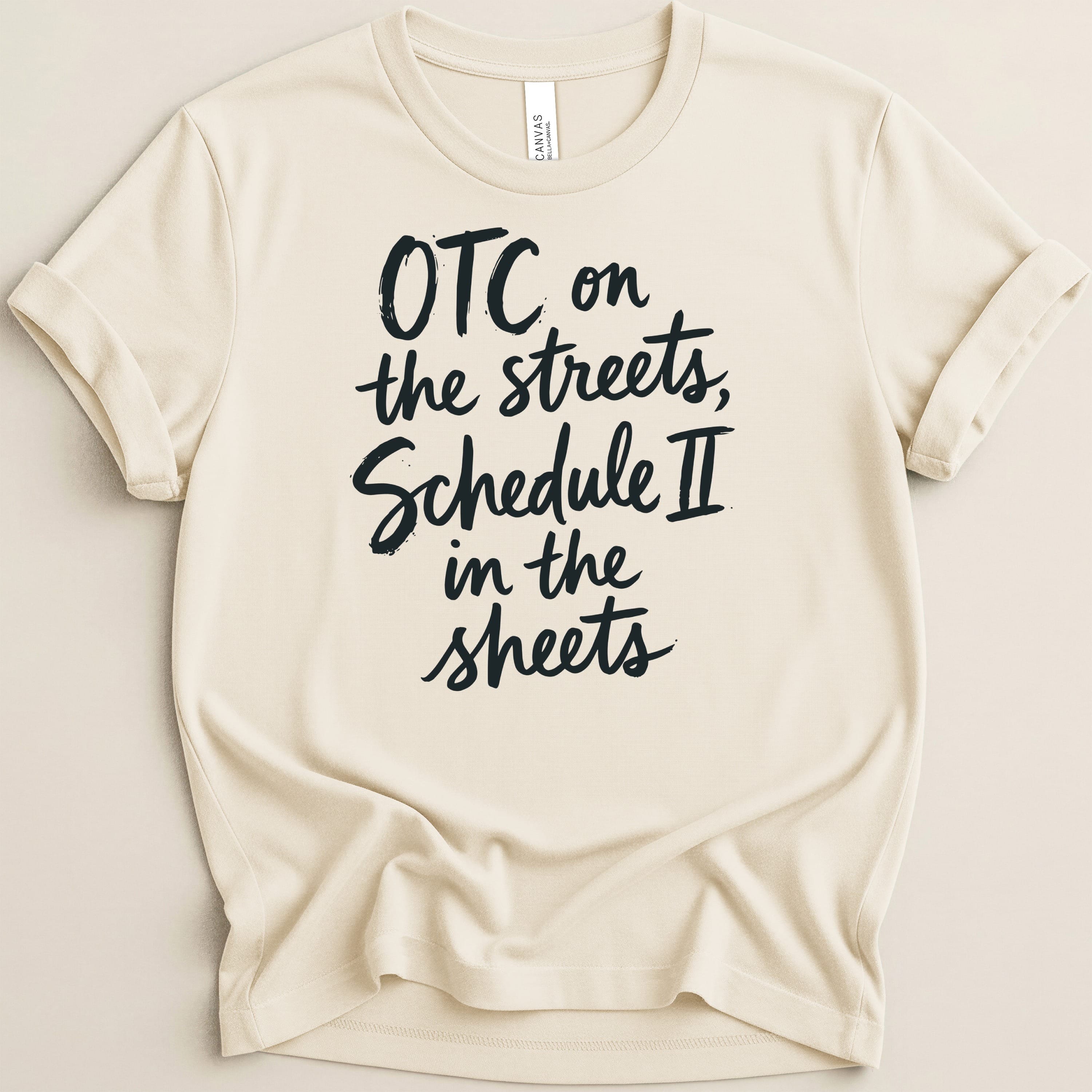 Cream t-shirt with black text "OTC on the streets, Schedule II in the sheets".