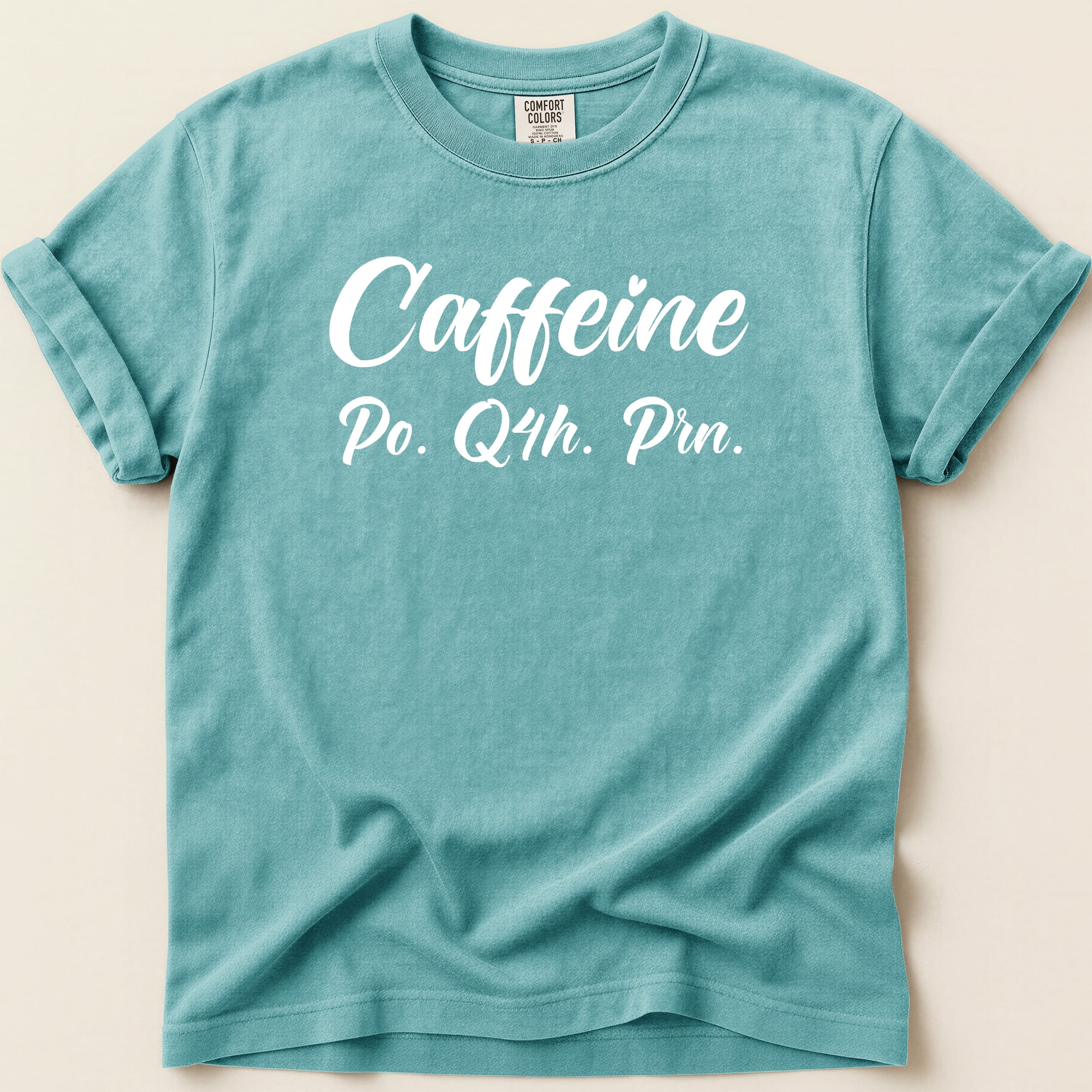 Teal t-shirt with "Caffeine Po. Q4h. Prn." text.