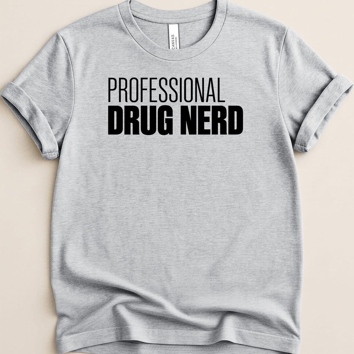 Light gray t-shirt with black text "PROFESSIONAL DRUG NERD".