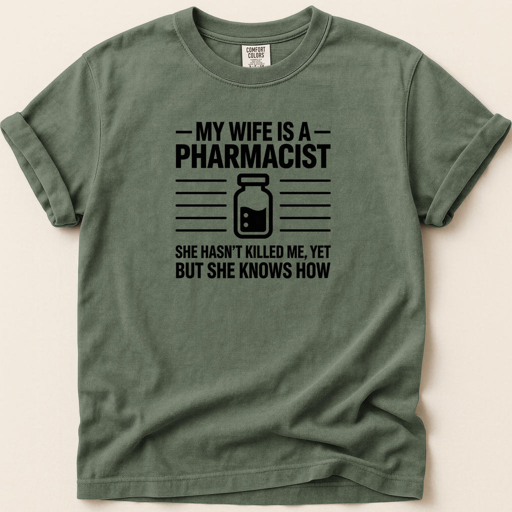 Green t-shirt with "My wife is a pharmacist" text and graphic.