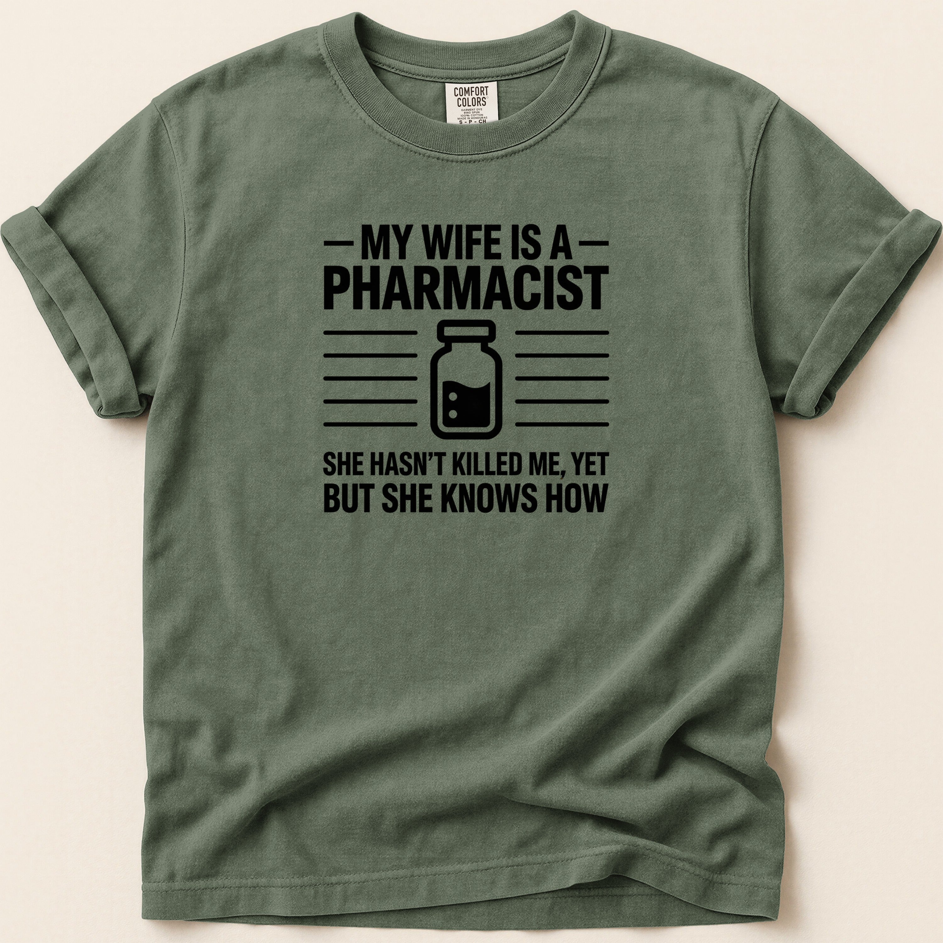 Green t-shirt with "My wife is a pharmacist" text and graphic.