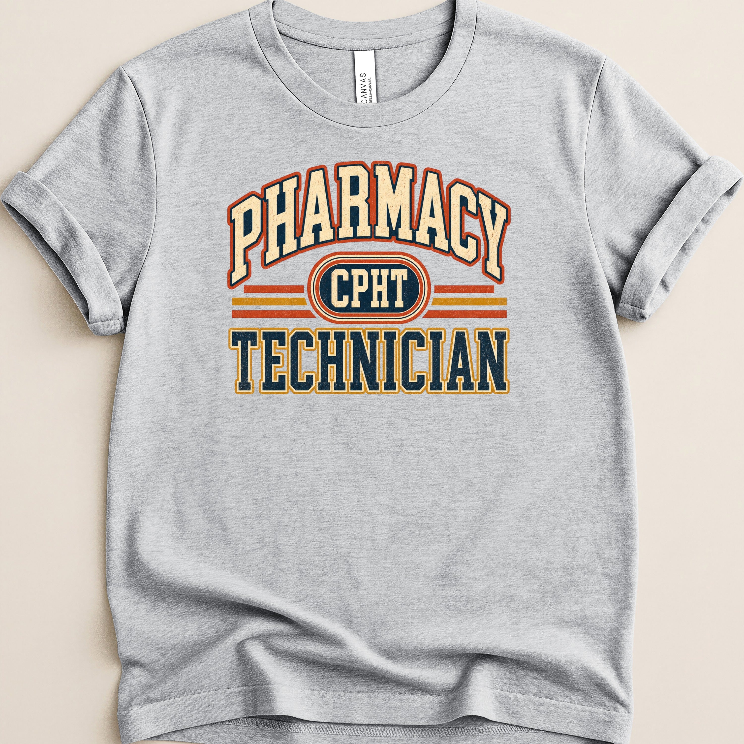 Grey t-shirt with "Pharmacy Technician" and "CPHT" text in vintage collegiate style.
