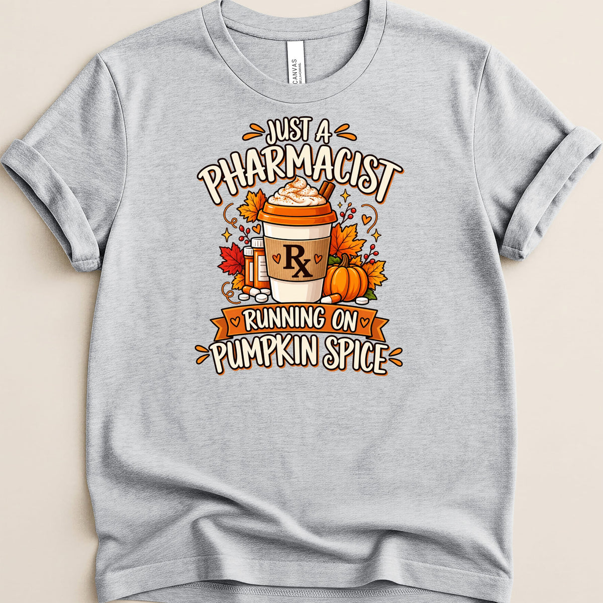 Light gray t-shirt featuring graphic text "JUST A PHARMACIST RUNNING ON PUMPKIN SPICE".