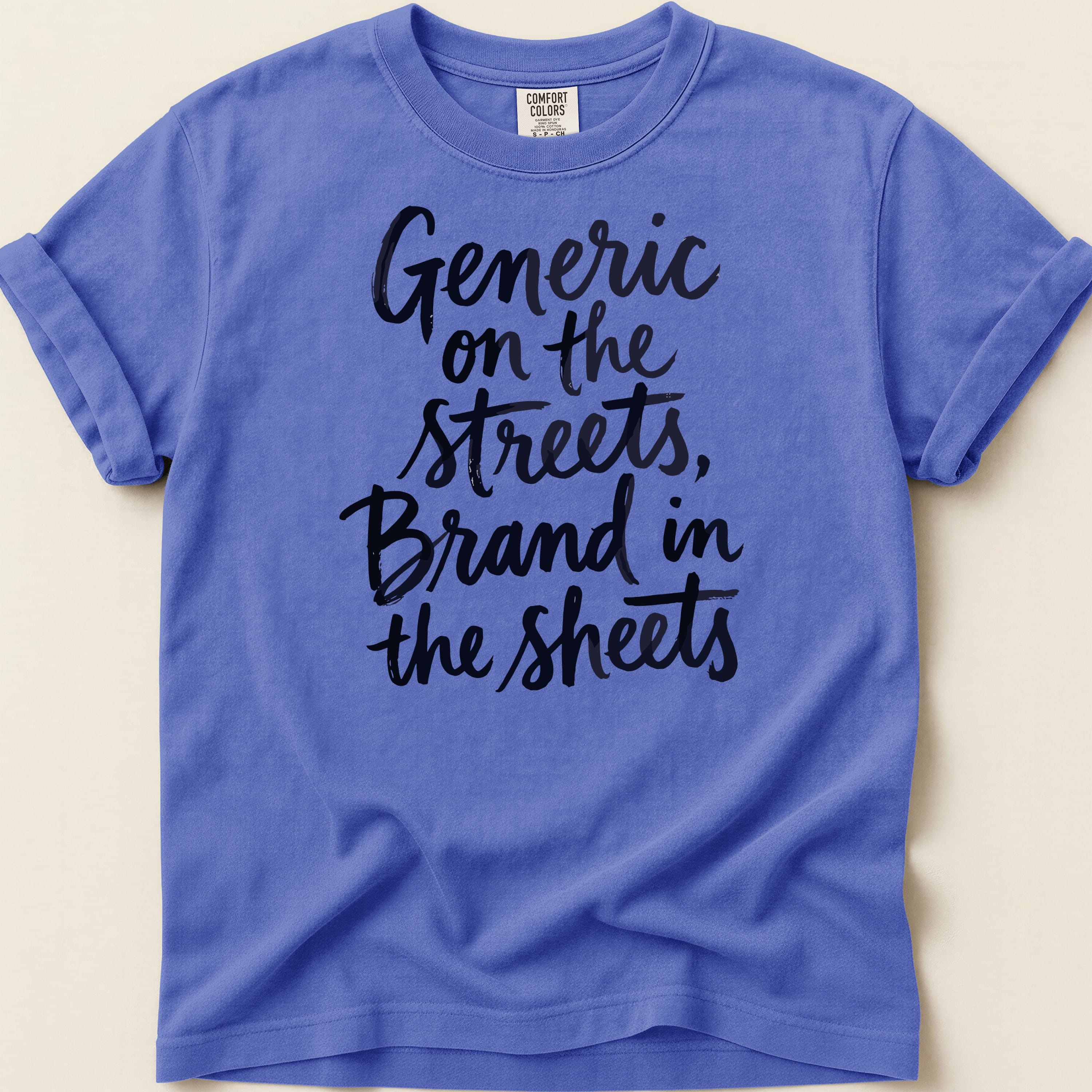 Purple t-shirt with black script text: "Generic on the streets, Brand in the sheets."