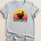 Gray t-shirt with "Pharmacy Life" text and a mortar and pestle over a sunset graphic.