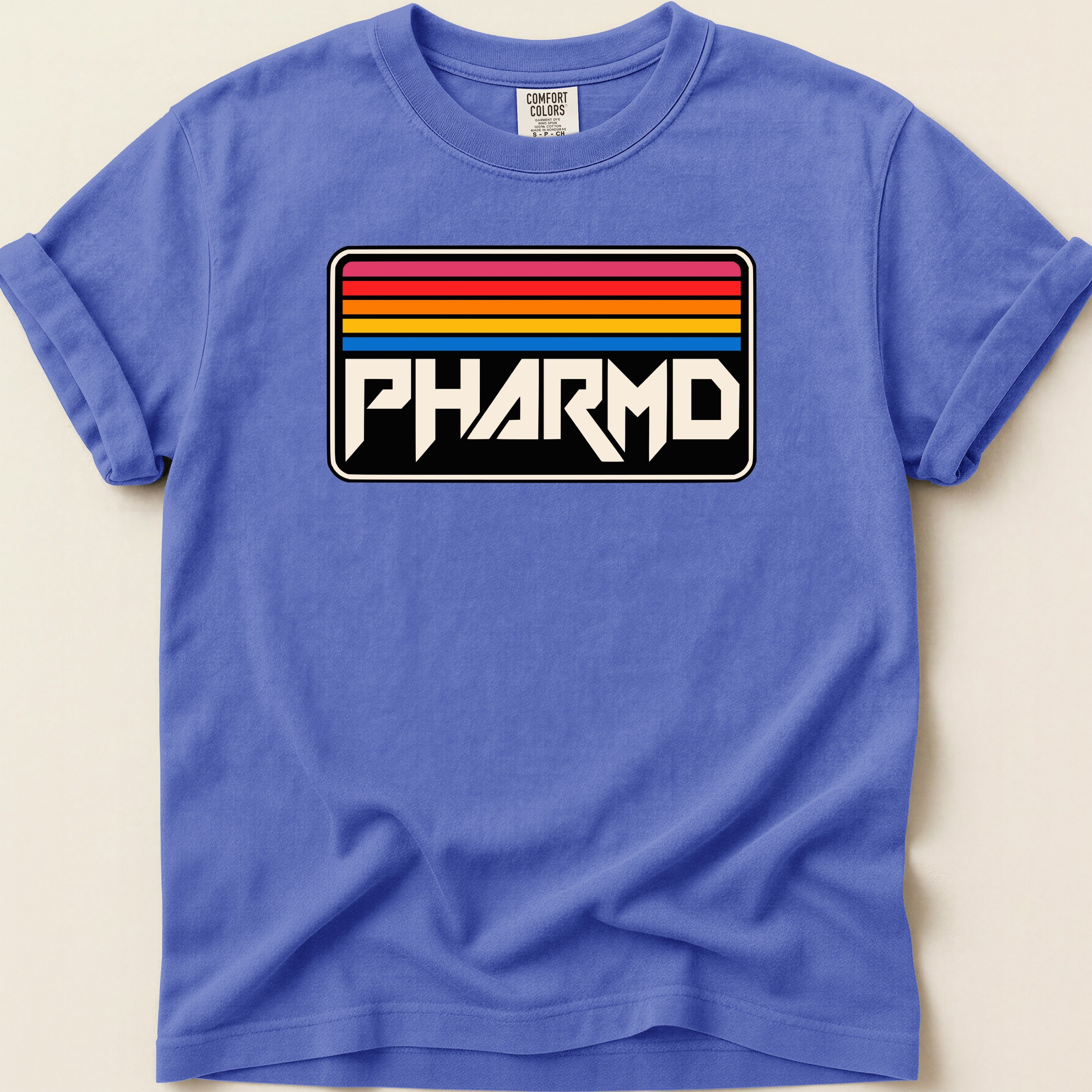 Comfort Colors t-shirt with retro rainbow stripes and PHARMD logo.