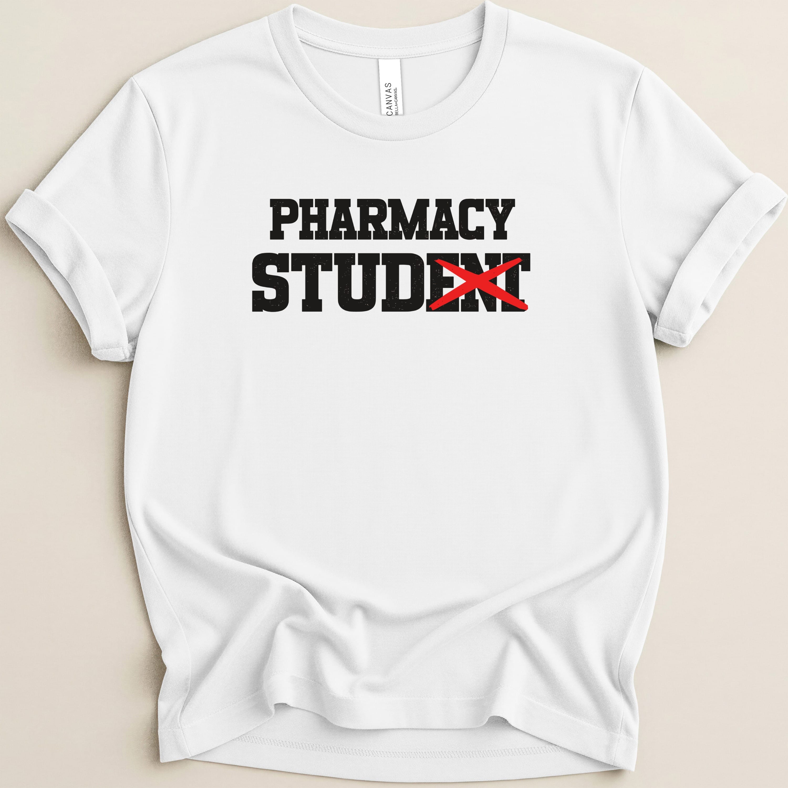 White t-shirt with bold black text "PHARMACY STUDENT" with a red x over "STUDENT".